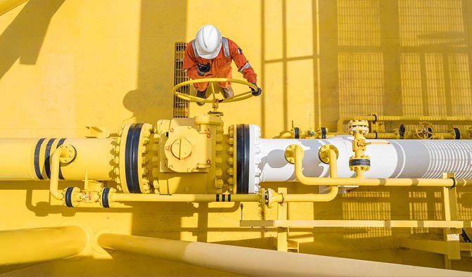 Production operator communicate between central control room by using radio to operate ball valve at offshore oil and gas processing platform for control gases and liquid crude oil process. 